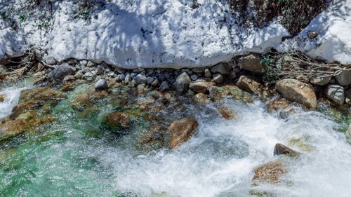 Free Snow-covered rocks and clear stream in a tranquil mountain setting, Sichuan, China. Stock Photo