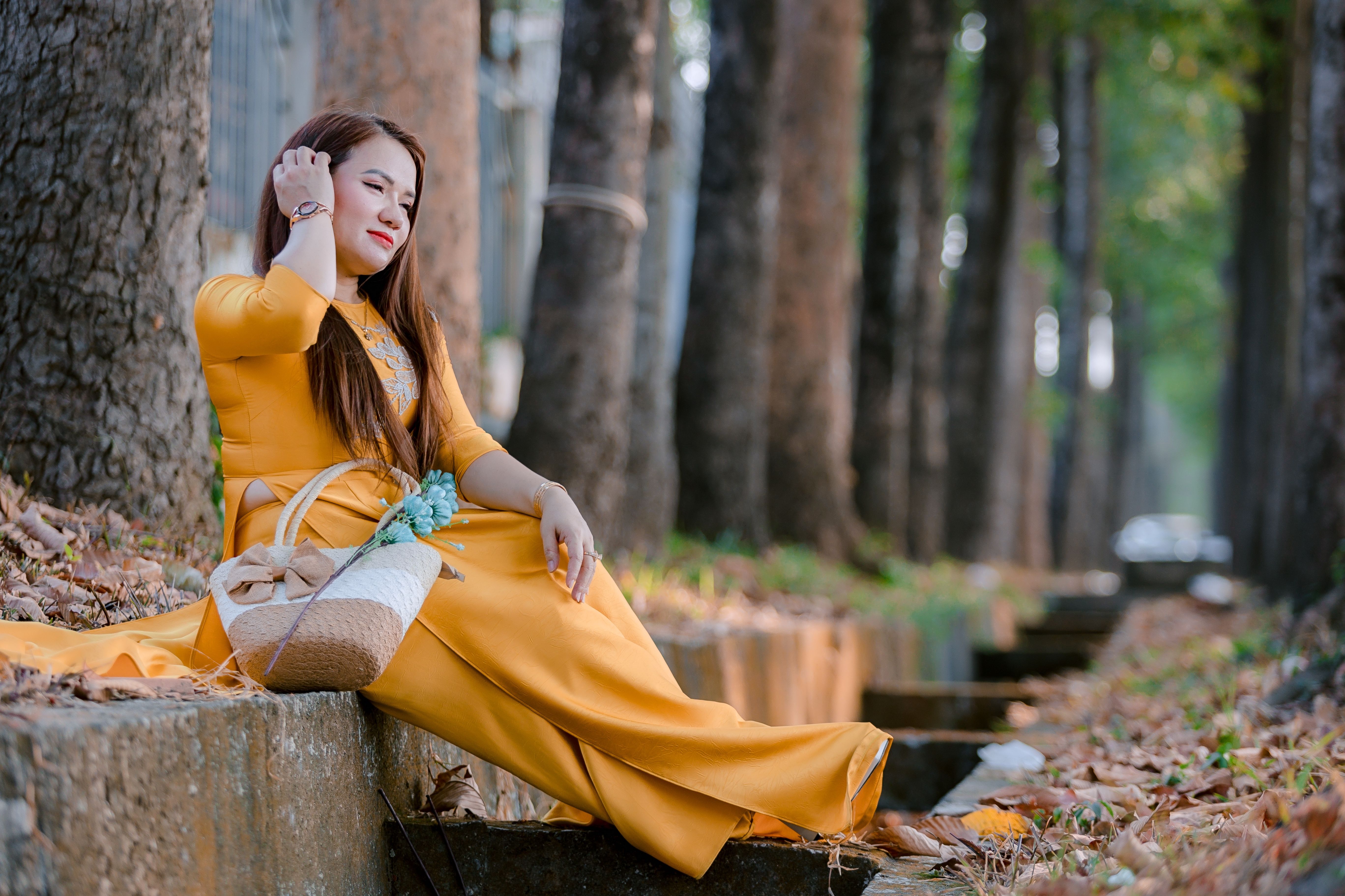 Woman in Yellow Dress Relaxing in Park · Free Stock Photo