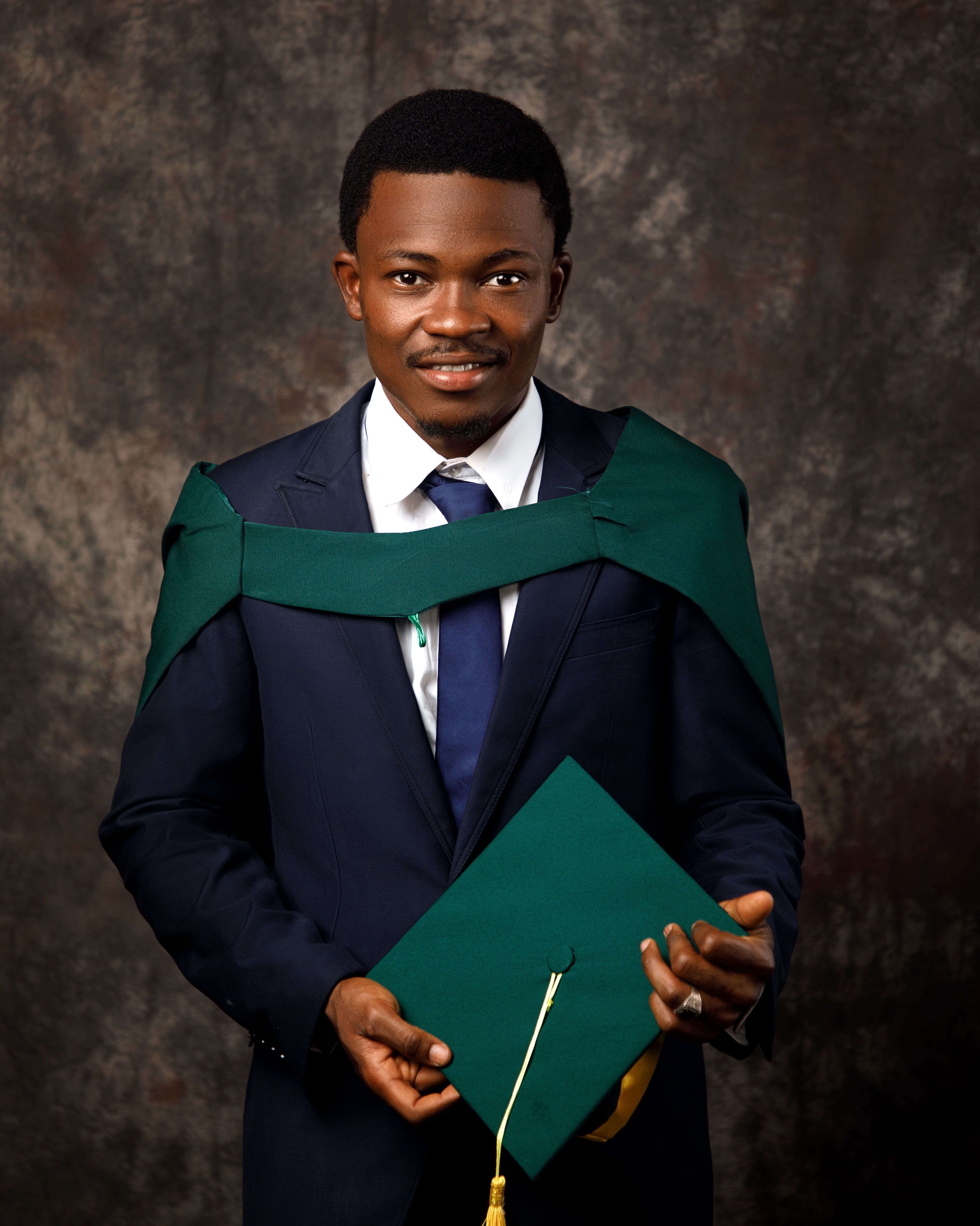 Man in Graduate Gown and Mortarboard  Free Stock Photo