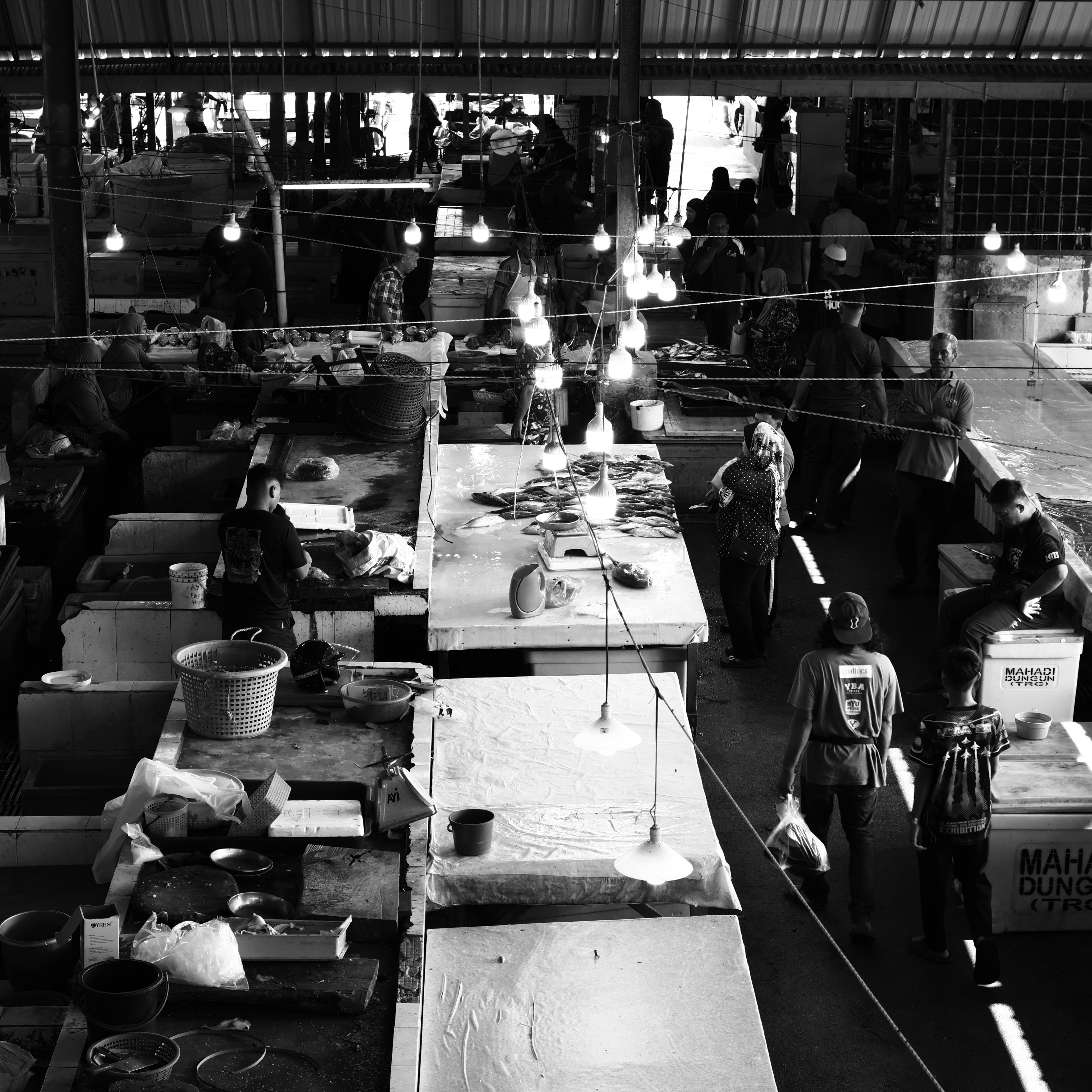 Black and white view of a lively indoor market scene in Kuala Dungun, Terengganu, Malaysia.