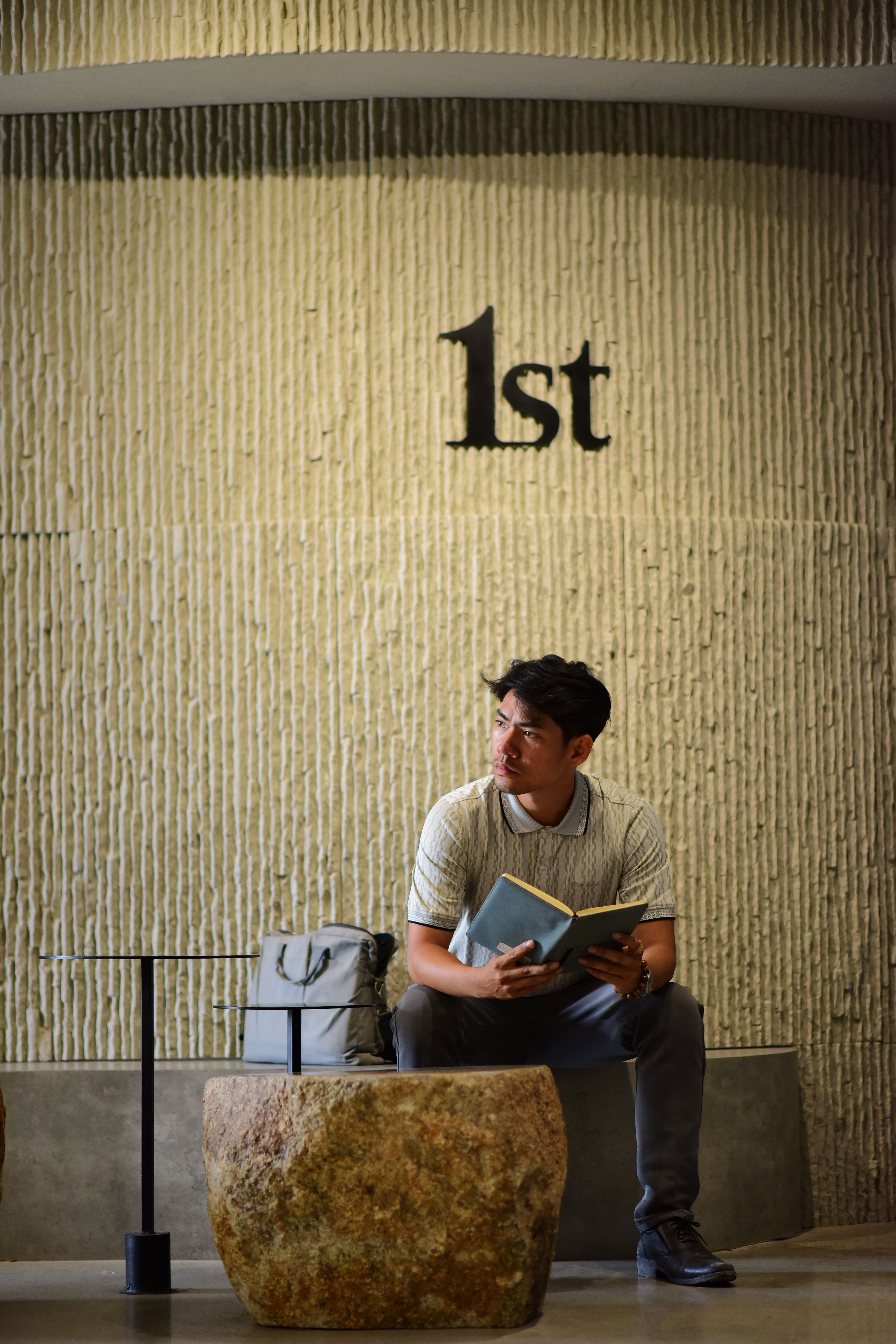 Young Man Reading in Modern Interior Space