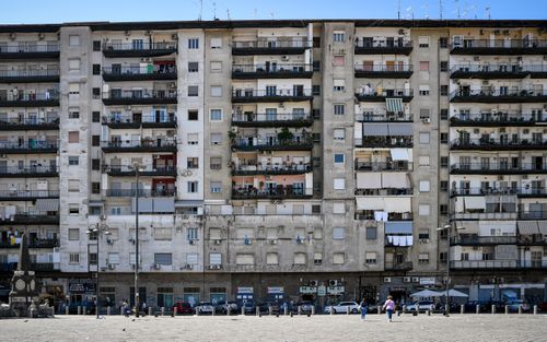 Free A detailed view of a multi-story residential building in Piazza Mercato, Naples, Italy, showcasing urban architecture. Stock Photo