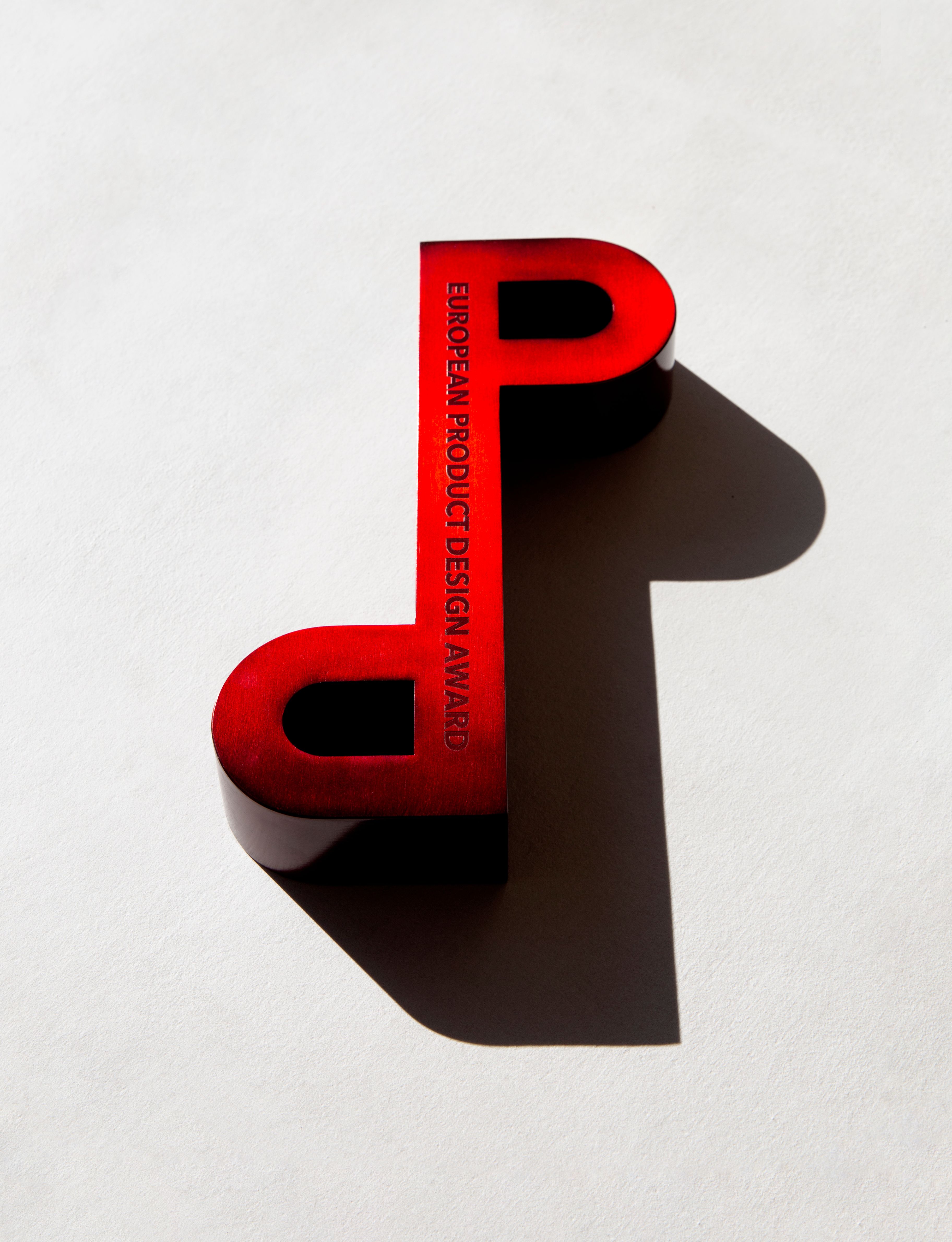 European Product Design Award trophy with striking red design on a white background.