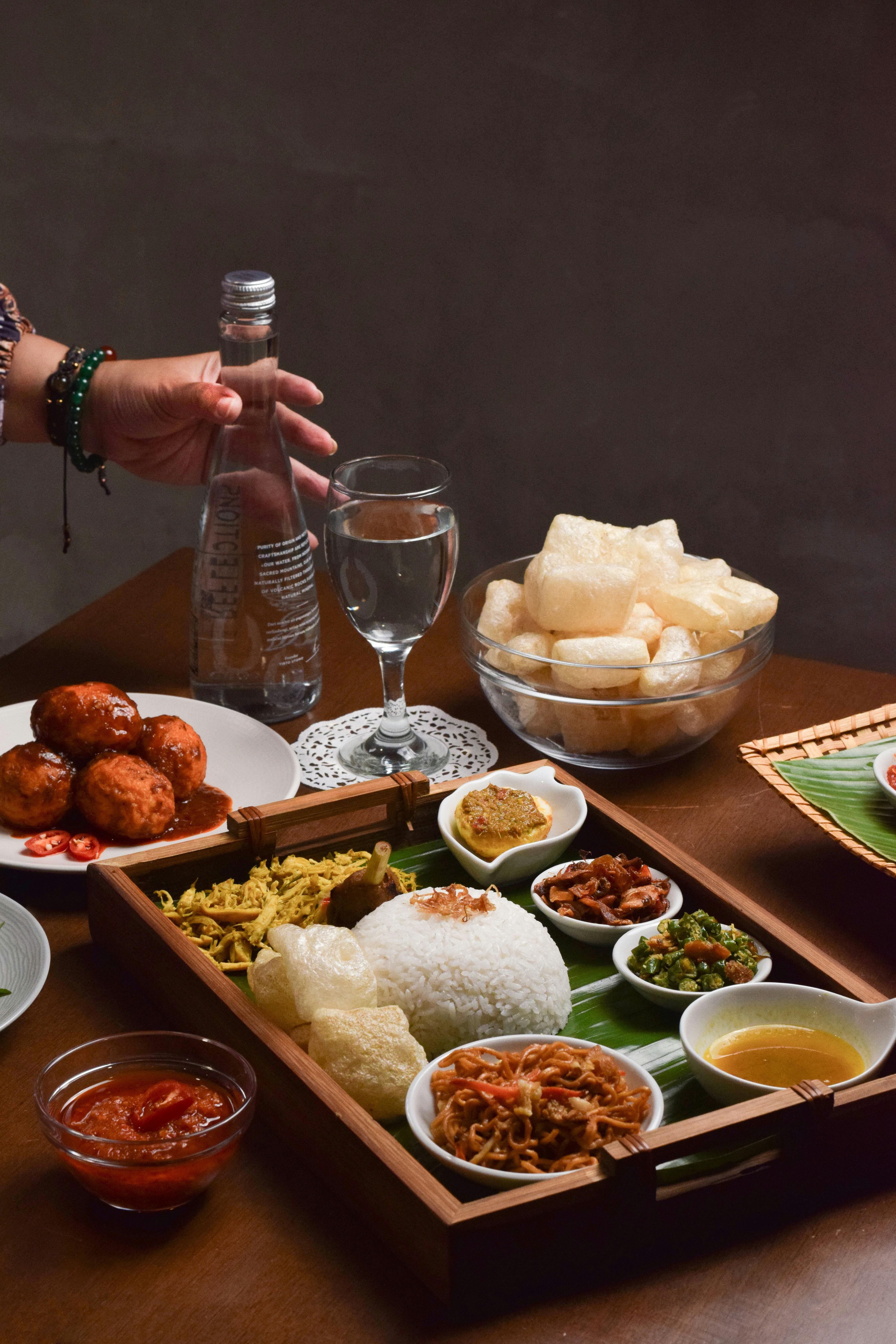 Plate of nasi campur with rice, sambal, fried chicken and vegetables at a traditional Balinese warung in Bali
