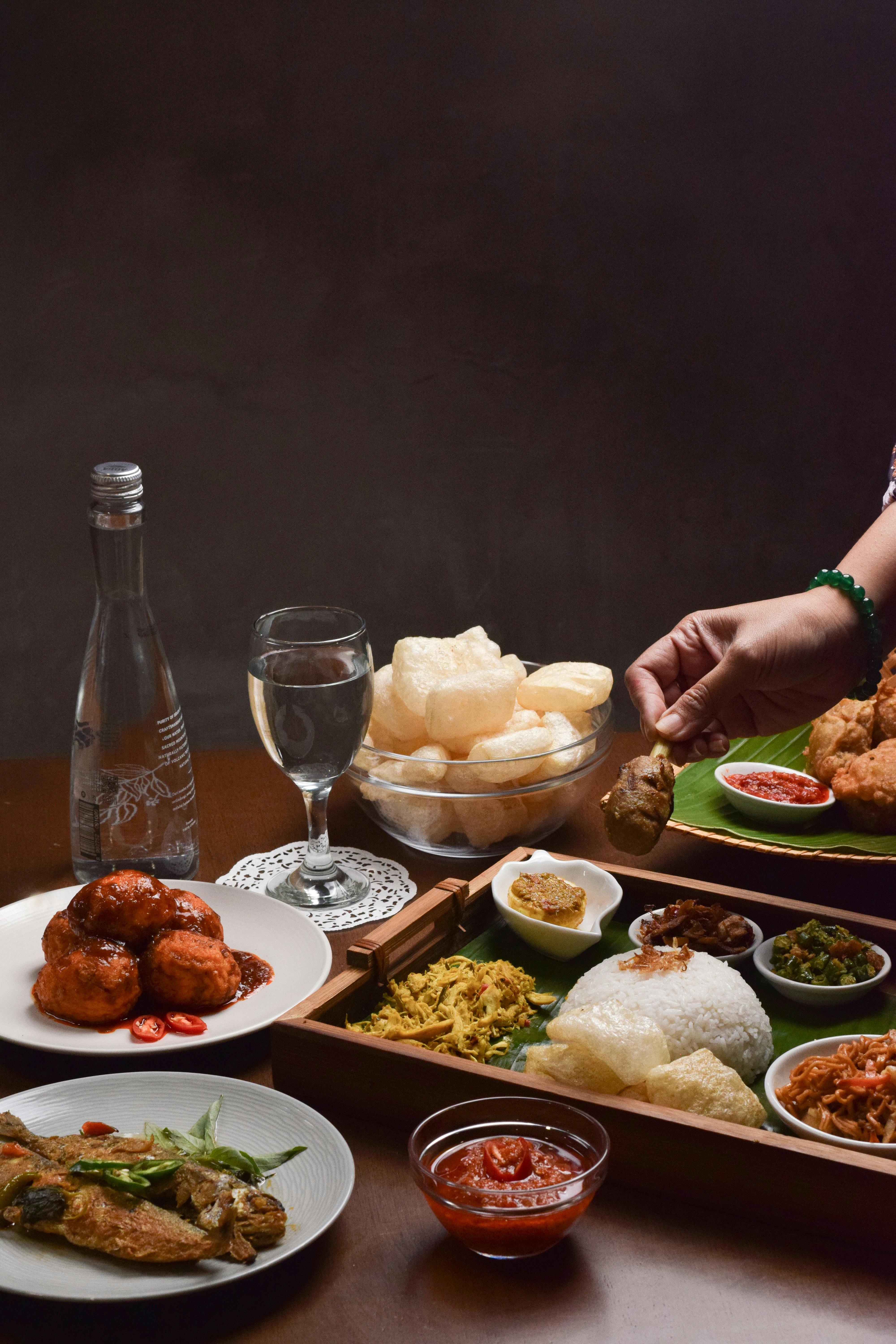A delicious assortment of traditional Indonesian dishes elegantly presented indoors in Jakarta.