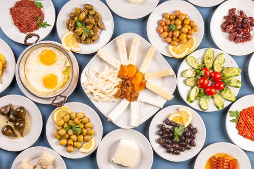 Free A vibrant traditional Turkish breakfast featuring various olives, cheeses, vegetables, and eggs. Stock Photo