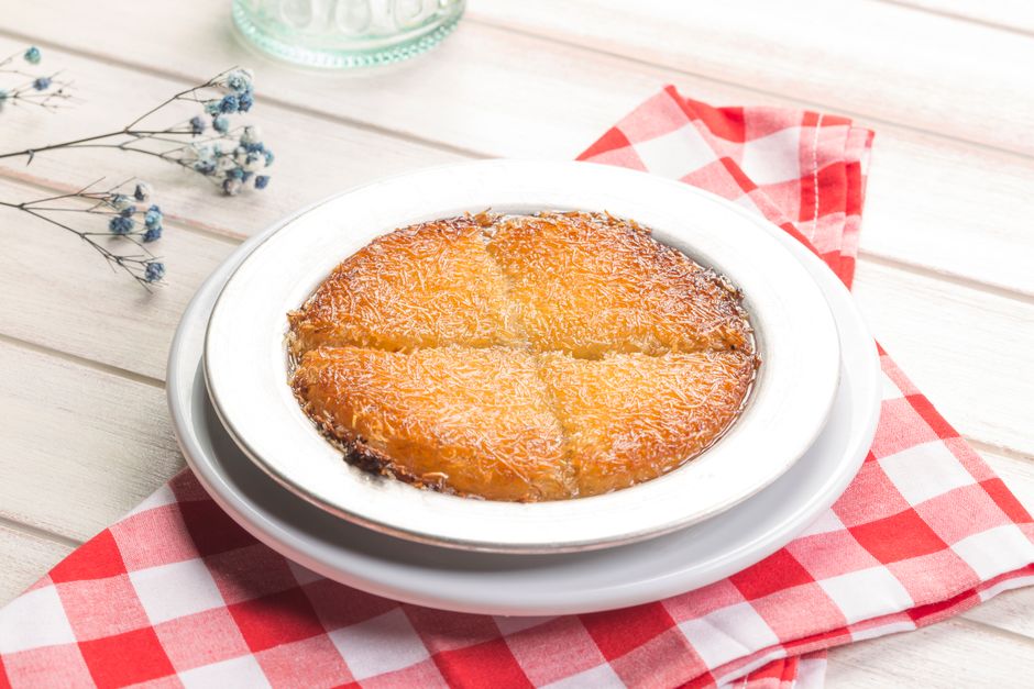 A serving of warm Knafeh, a traditional sweet cheese pastry from Jordan