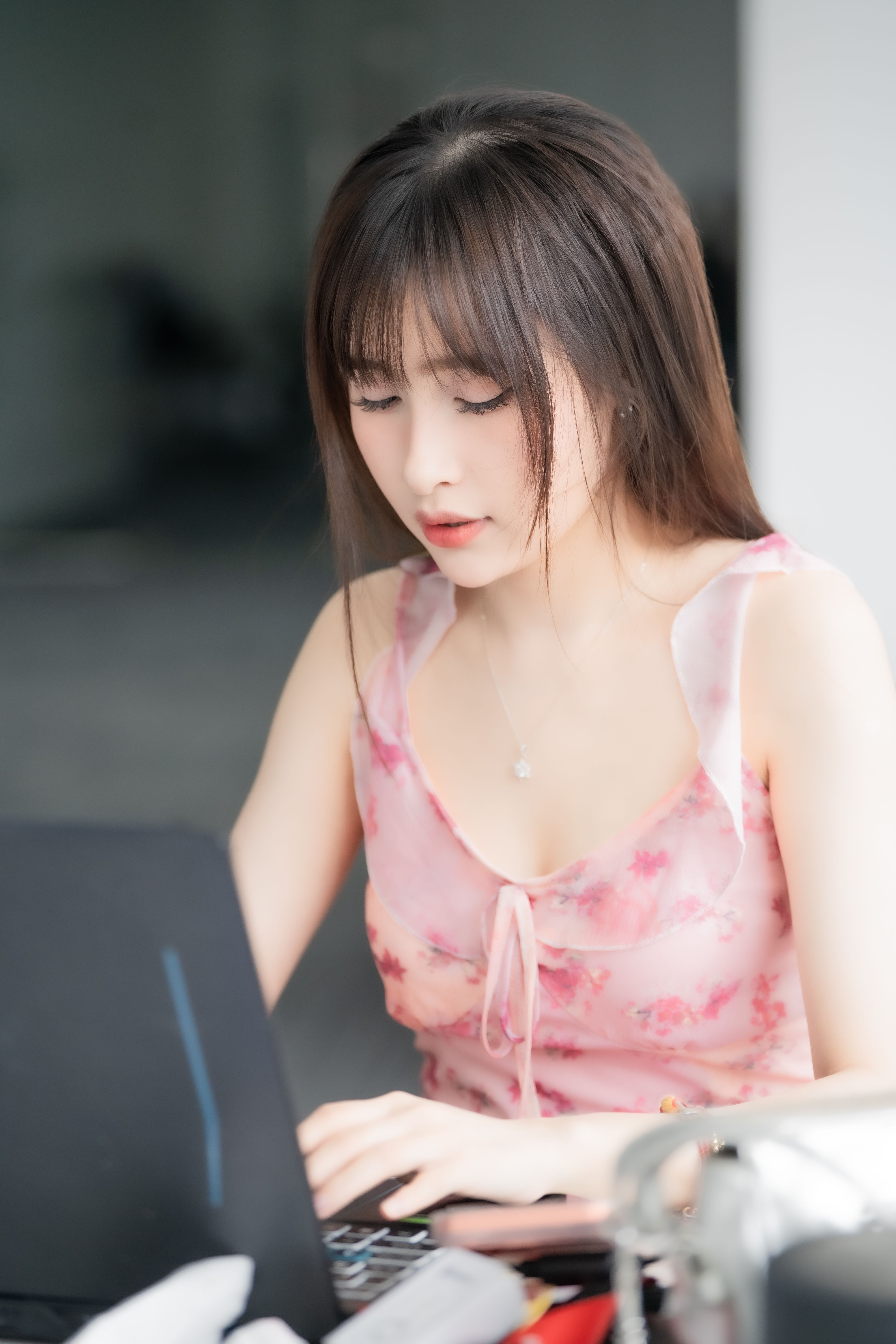 Young Woman Working on Laptop Indoors