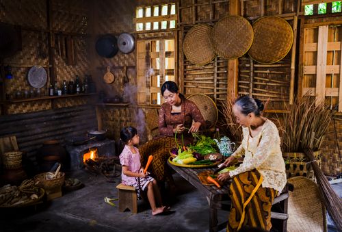 Free A traditional Indonesian family cooking fresh vegetables in a rustic kitchen setting. Stock Photo