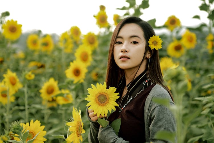 Positive Asian Woman In Sunflower Field