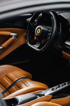 Close-up of a luxury car's interior featuring elegant leather seating and a stylish steering wheel.
