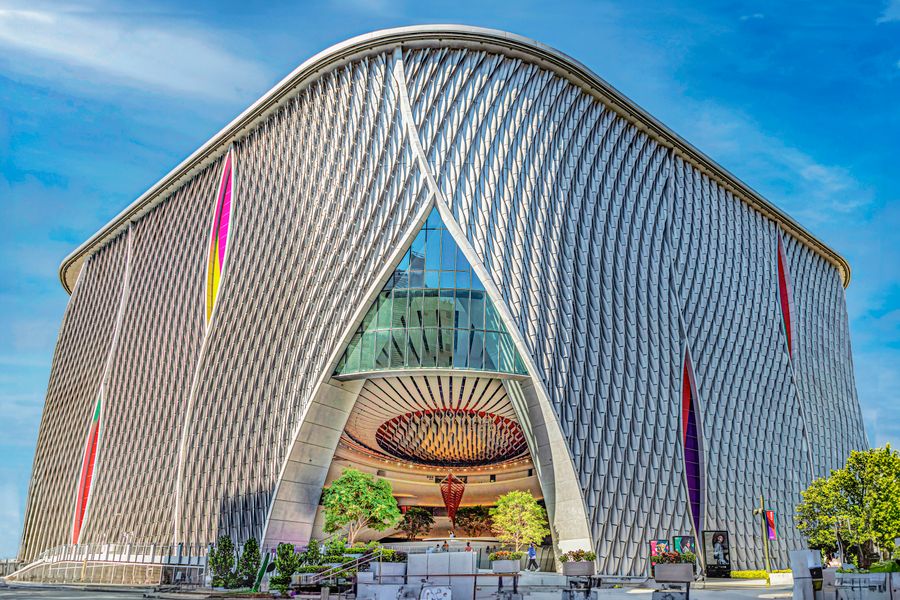 Moscone West convention center exterior with sweeping metallic facade and colorful banners in San Francisco