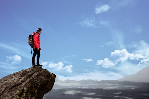 Free Man Standing on Cliff Photography Stock Photo