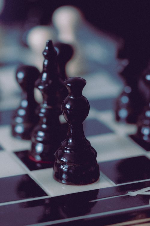 Free Detailed shot of black chess pieces on a checkered board, highlighting strategy. Stock Photo