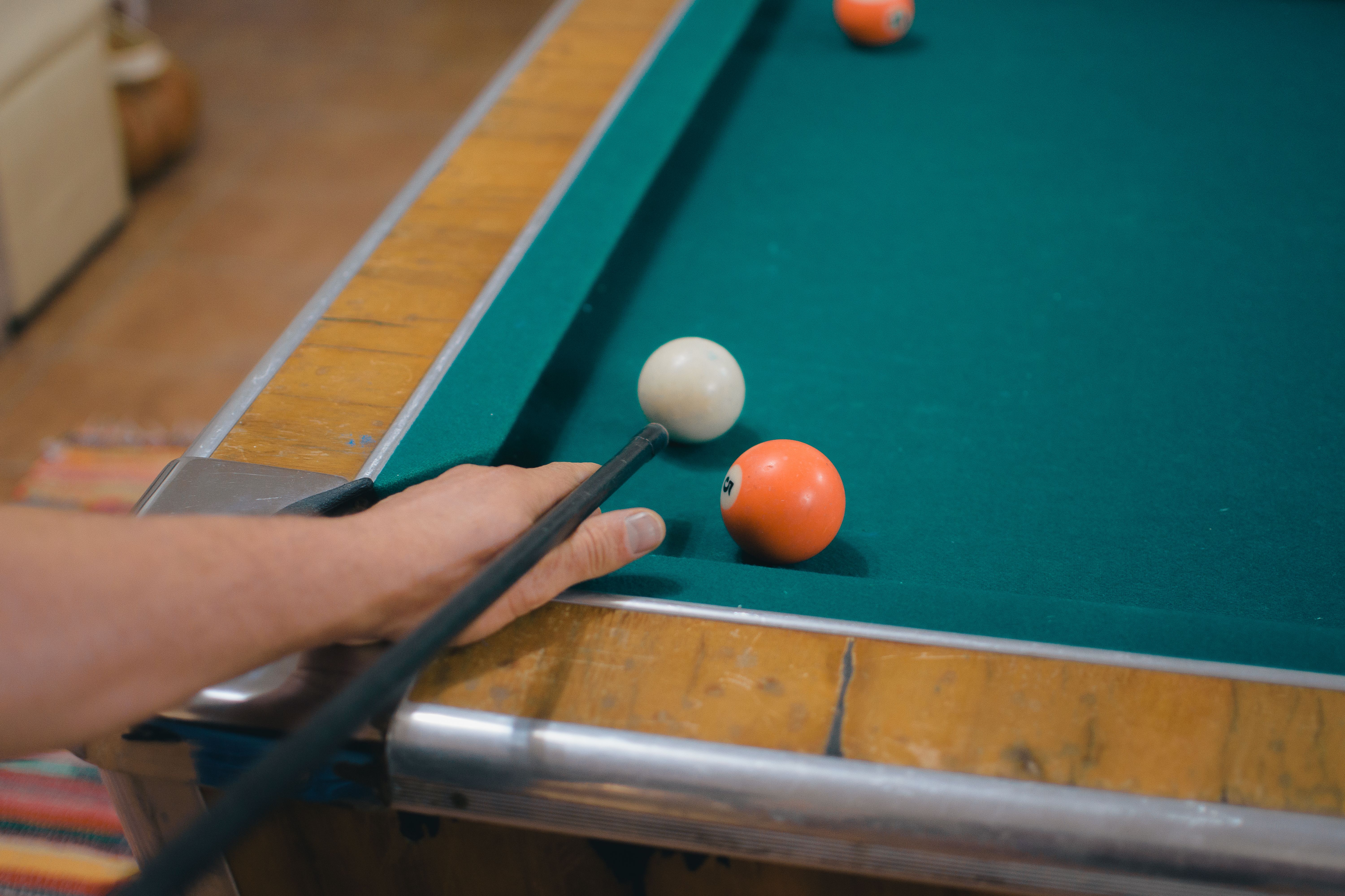 Close-Up Shot of Hand Playing Billiards · Free Stock Photo