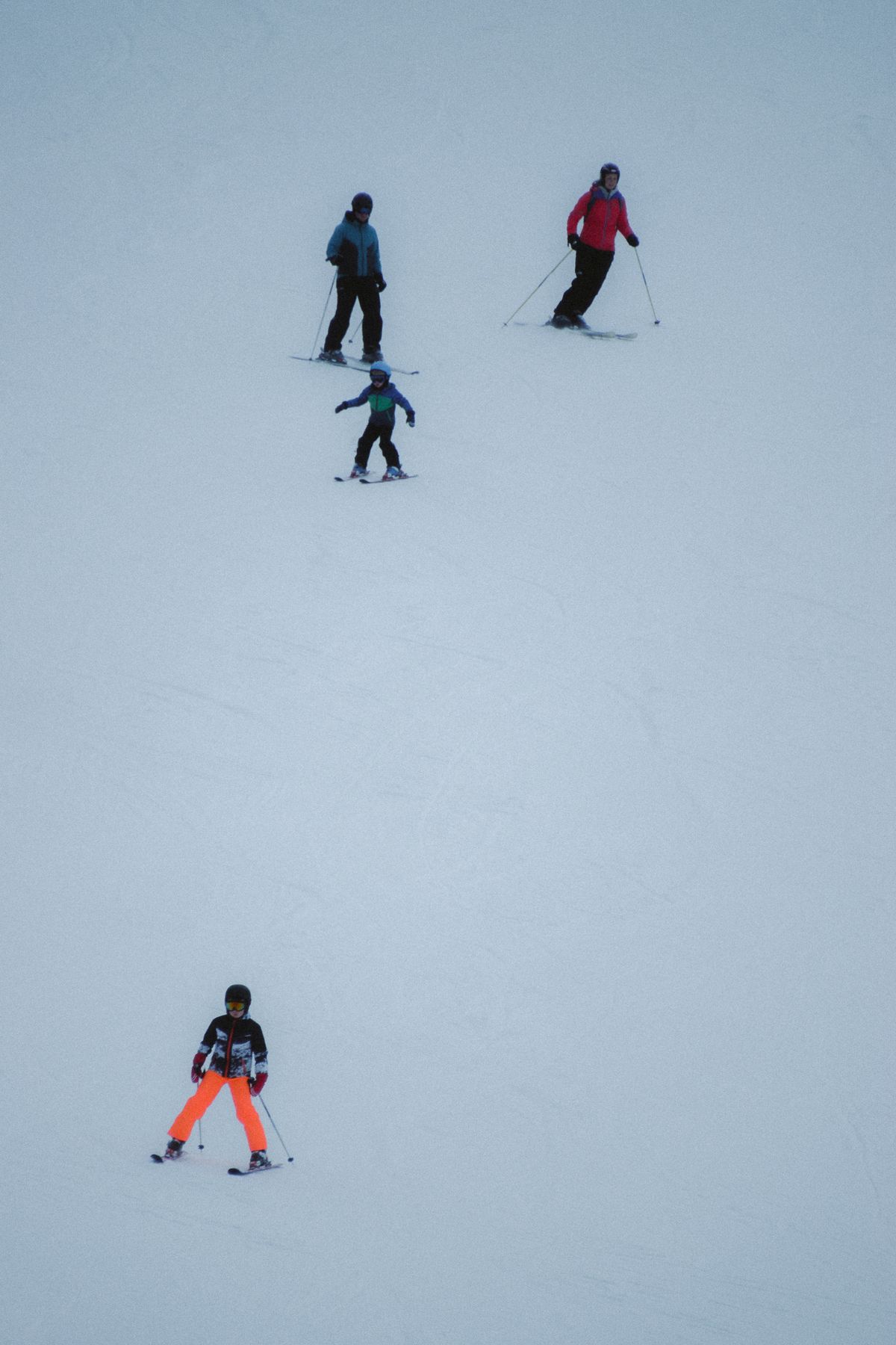Family of four skiing together