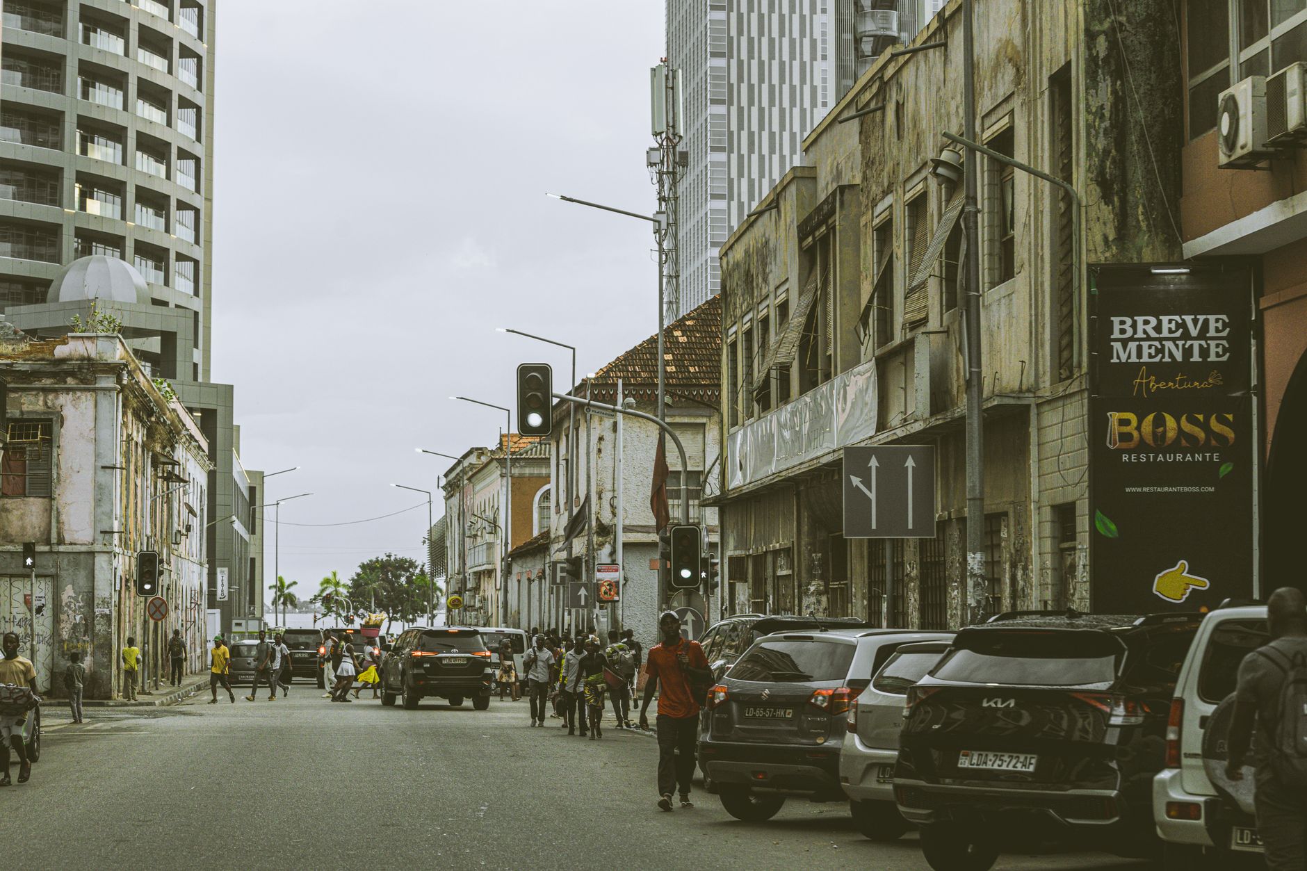Bustling street scene in downtown Luanda, Angola with historic and modern buildings.
