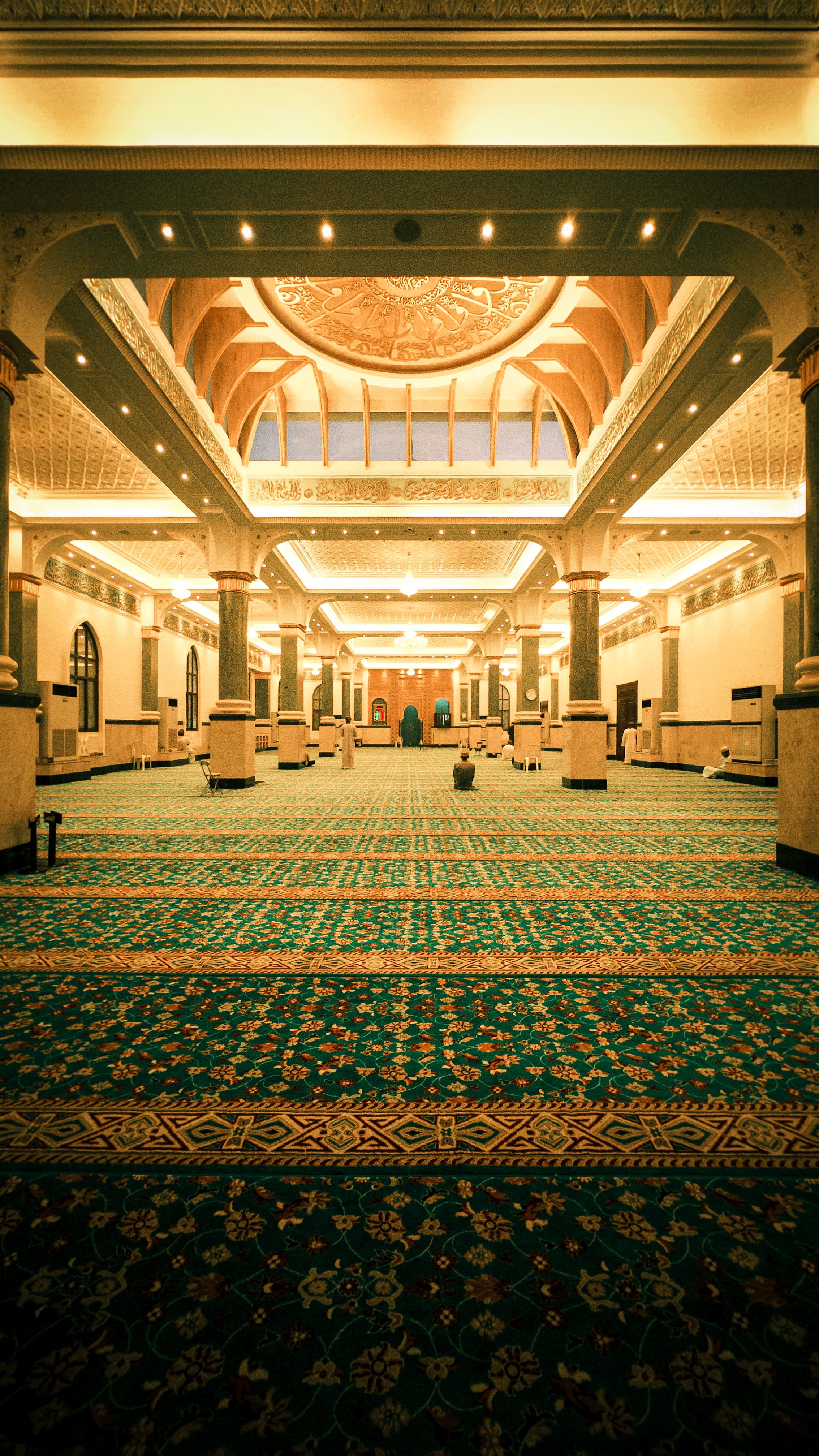 Elegant mosque prayer hall with patterned carpet