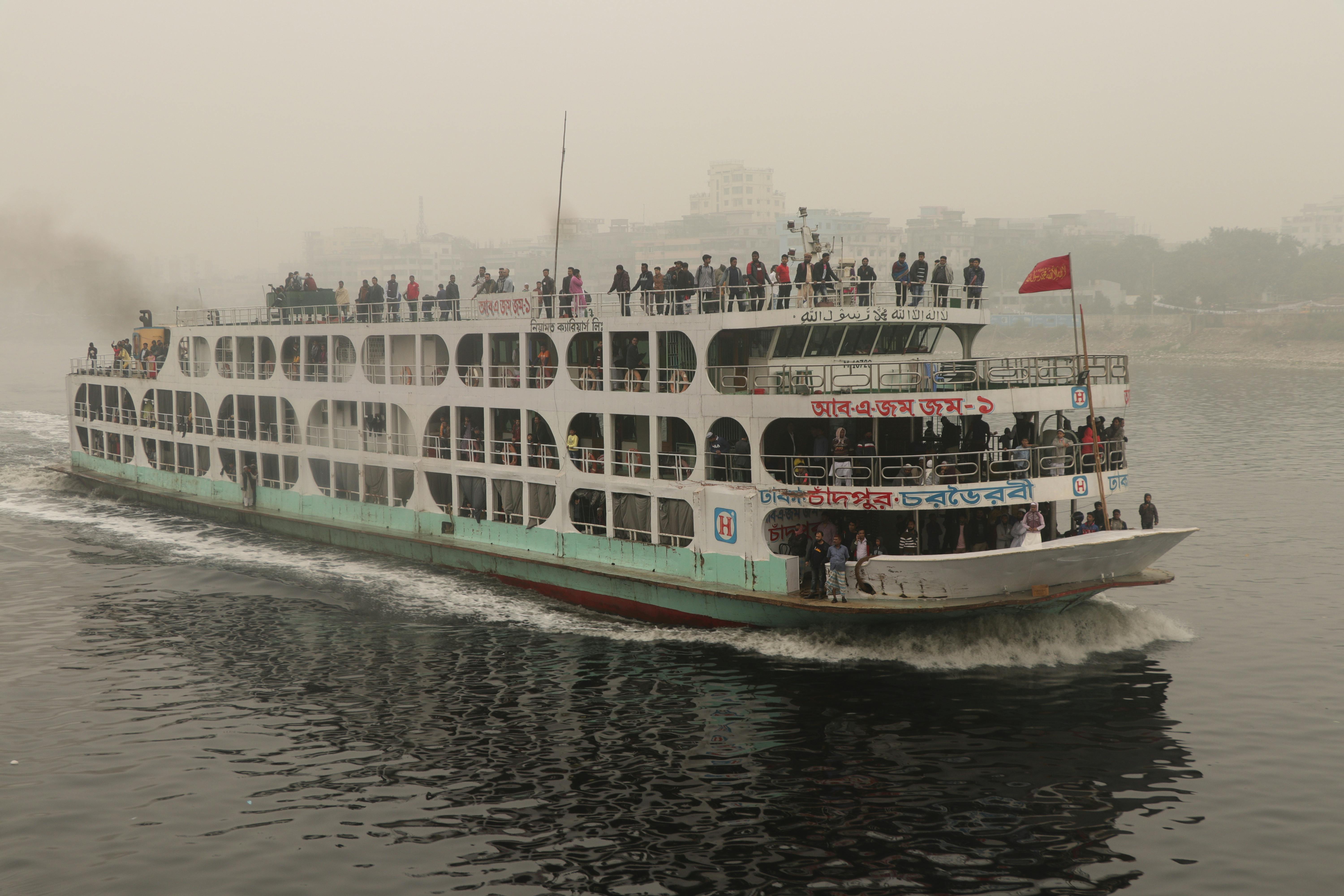 white river boat with people on water