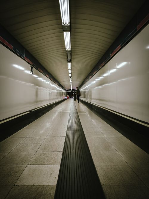 Free An empty underground passage with modern lighting and architectural symmetry. Stock Photo