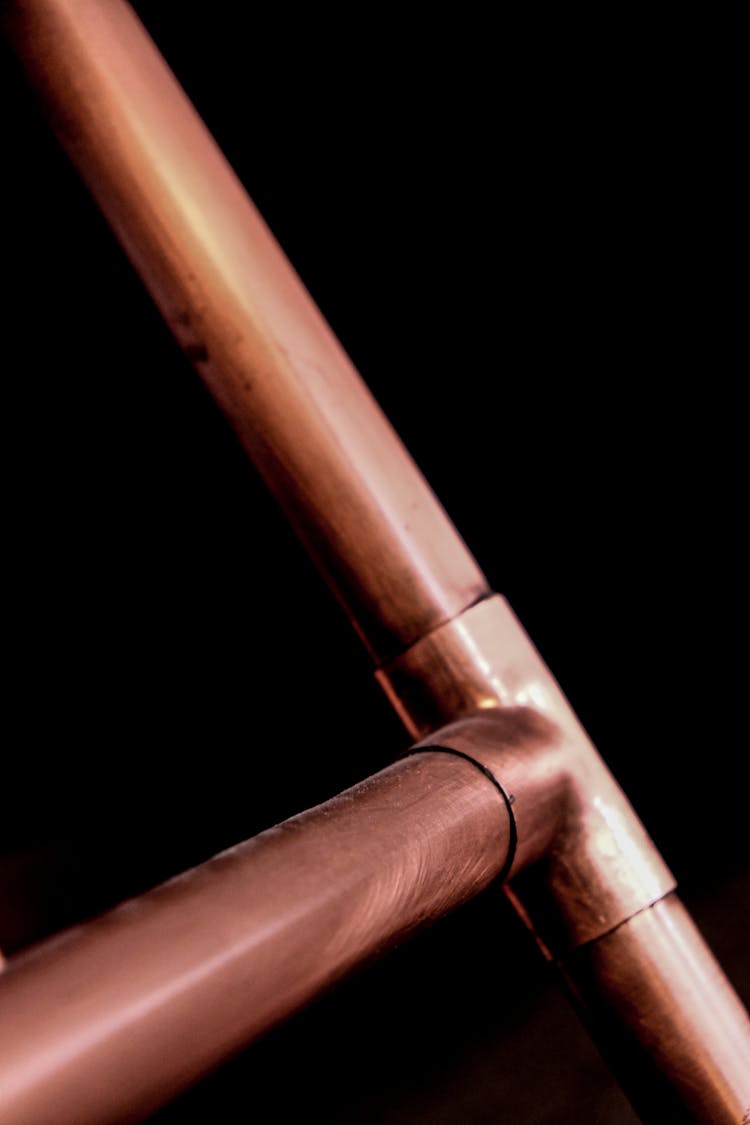 Copper Pipes On Black Background