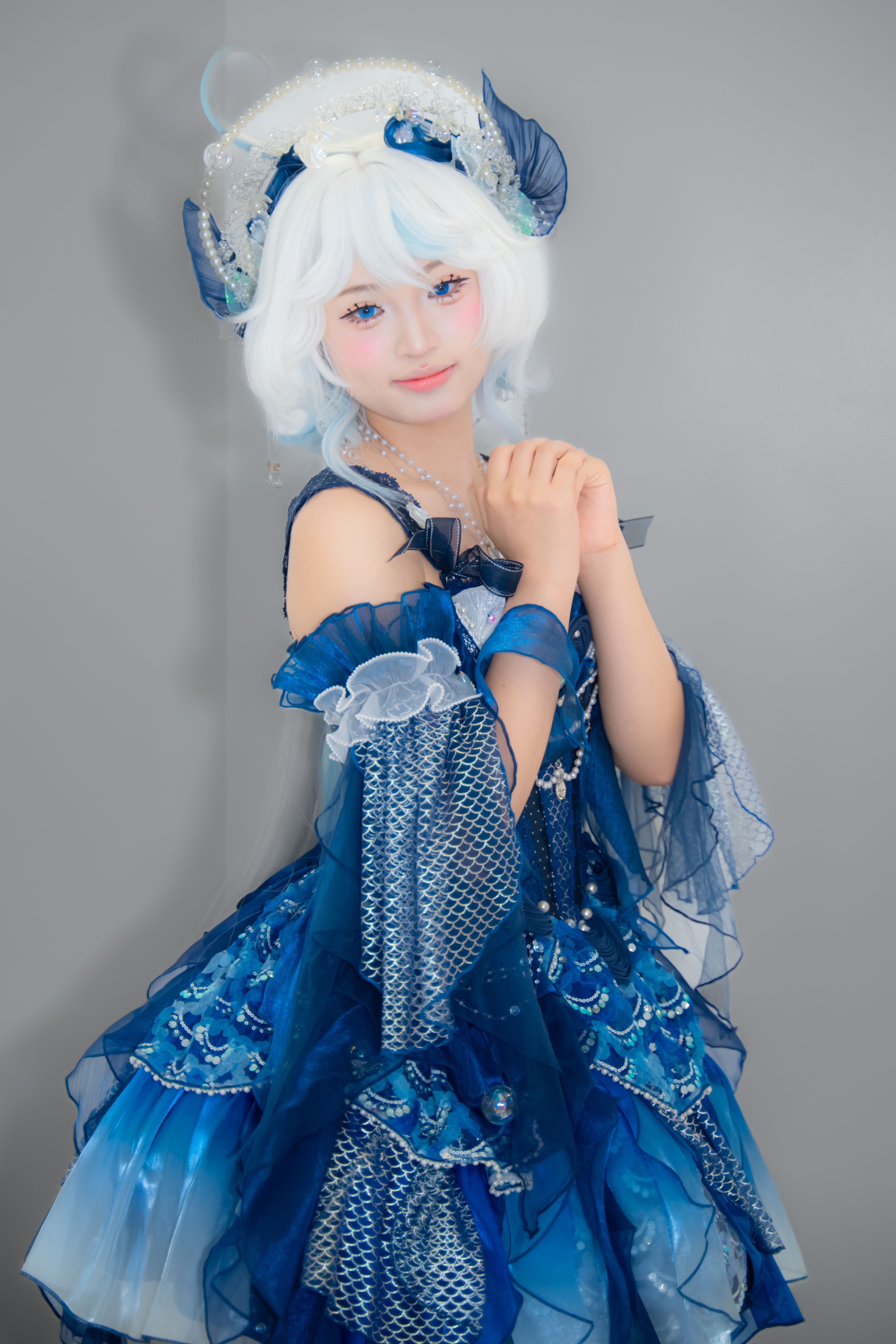A captivating portrait of a person in elaborate blue fantasy cosplay attire.