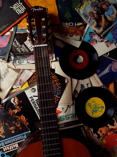 Guitar on vinyl disks with music of 80s