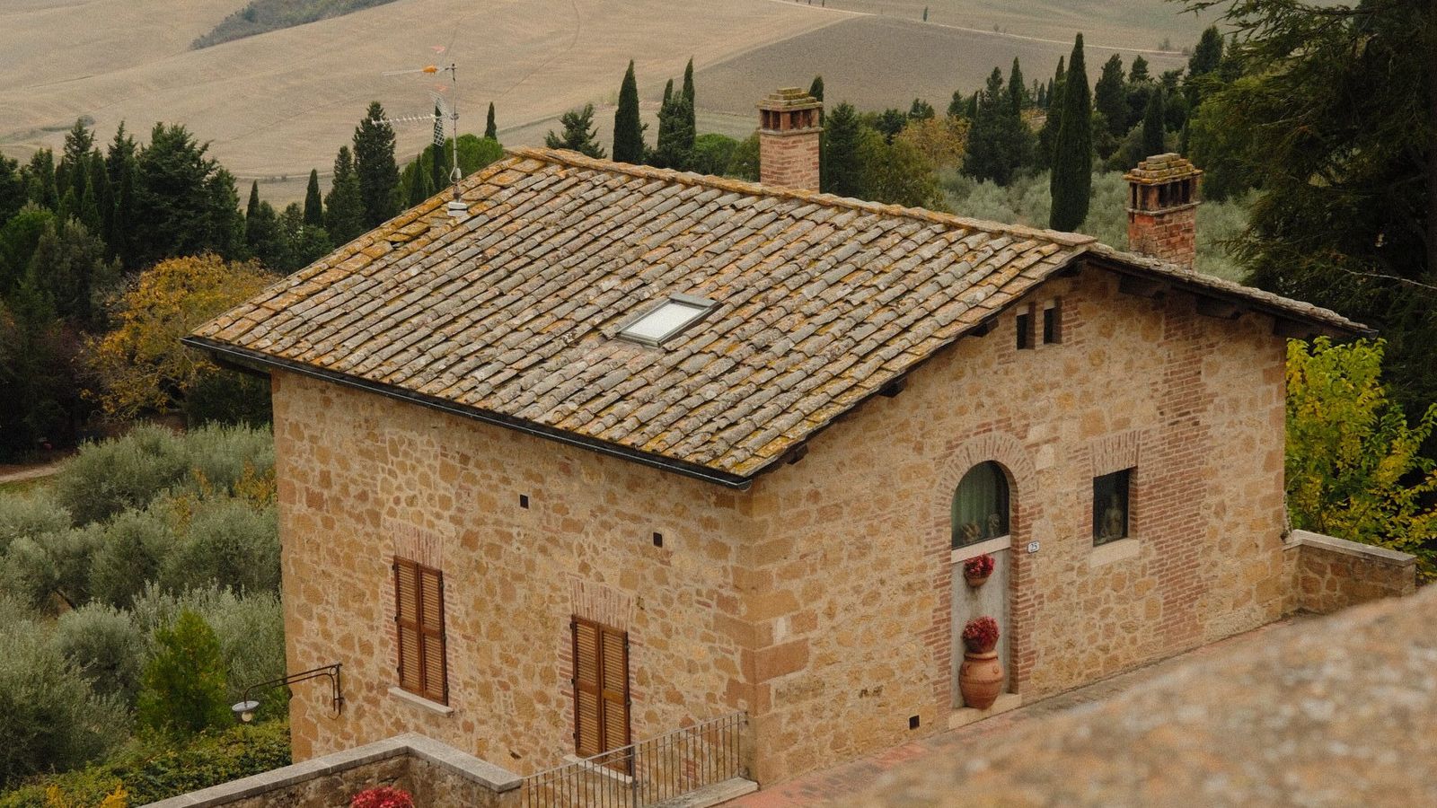 A stone villa among cypress trees in the Italian countryside with no people in the frame, a real free-to-use photo chosen because The Mob is set in an Italian villa. It is not a still from the series and it does not show the cast