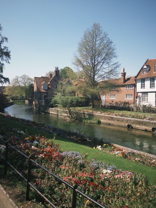 Free Charming riverside scene of historical buildings in Canterbury, England, during spring. Stock Photo