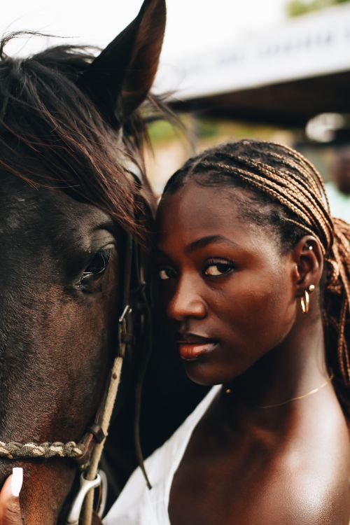 Free Intimate portrait of a woman standing closely with a horse in an outdoor setting. Stock Photo