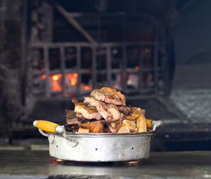 Delicious traditional Uruguayan Asado served hot, showcasing succulent grilled meats by a wood-fired grill.