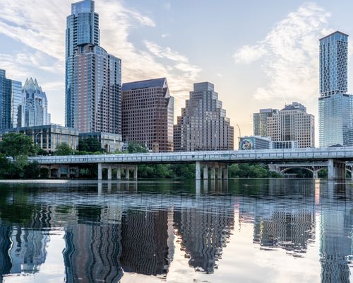 Free Beautiful view of Austin's skyline with reflections in Lady Bird Lake during daytime. Stock Photo
