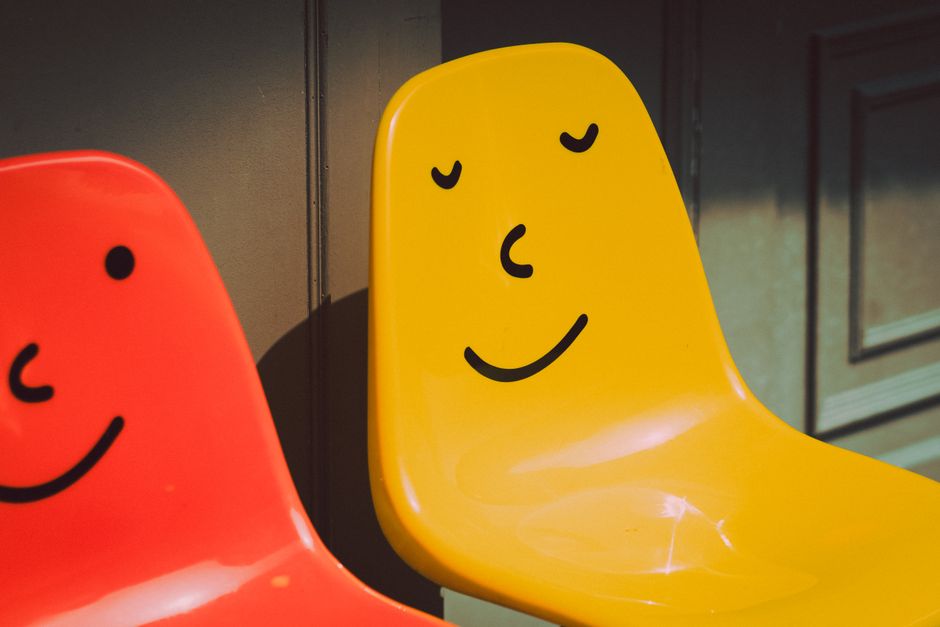 Bright and cheerful chairs with painted smiling faces, perfect for lively spaces.