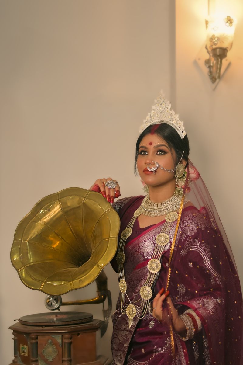 Woman in traditional occasion wear beside a gramophone