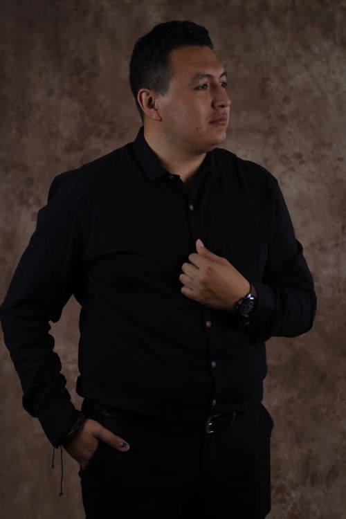 Free Sophisticated portrait of a man in a black shirt against a brown textured background. Stock Photo