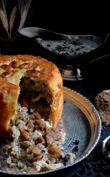 A delicious traditional pilaf wrapped in a golden pastry with almonds, perfect for festive meals.