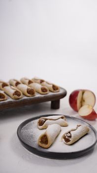 A close-up of homemade apple pastries dusted with powdered sugar, perfect for a sweet treat.