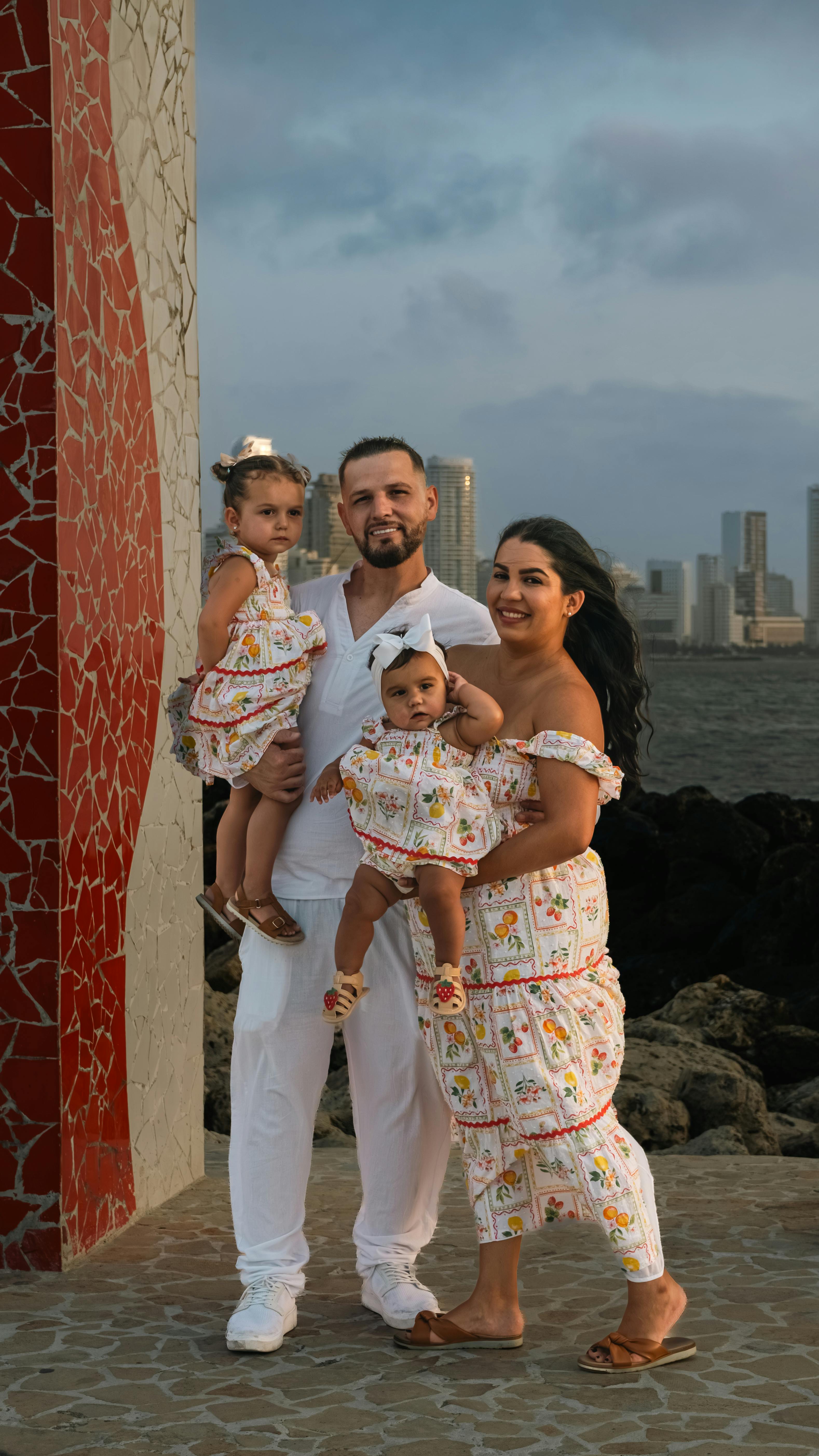 Family enjoying a day by the sea with cityscape in the background, capturing cherished moments together.