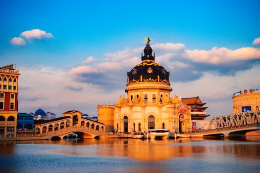 Breathtaking view of a grand architectural structure reflected on a calm lake at sunset.