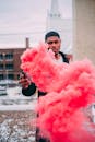 Black man with activated flare with pink fume