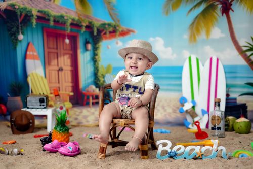 Free Cute baby sitting on beach sand with props, offering an adorable summer vibe. Stock Photo