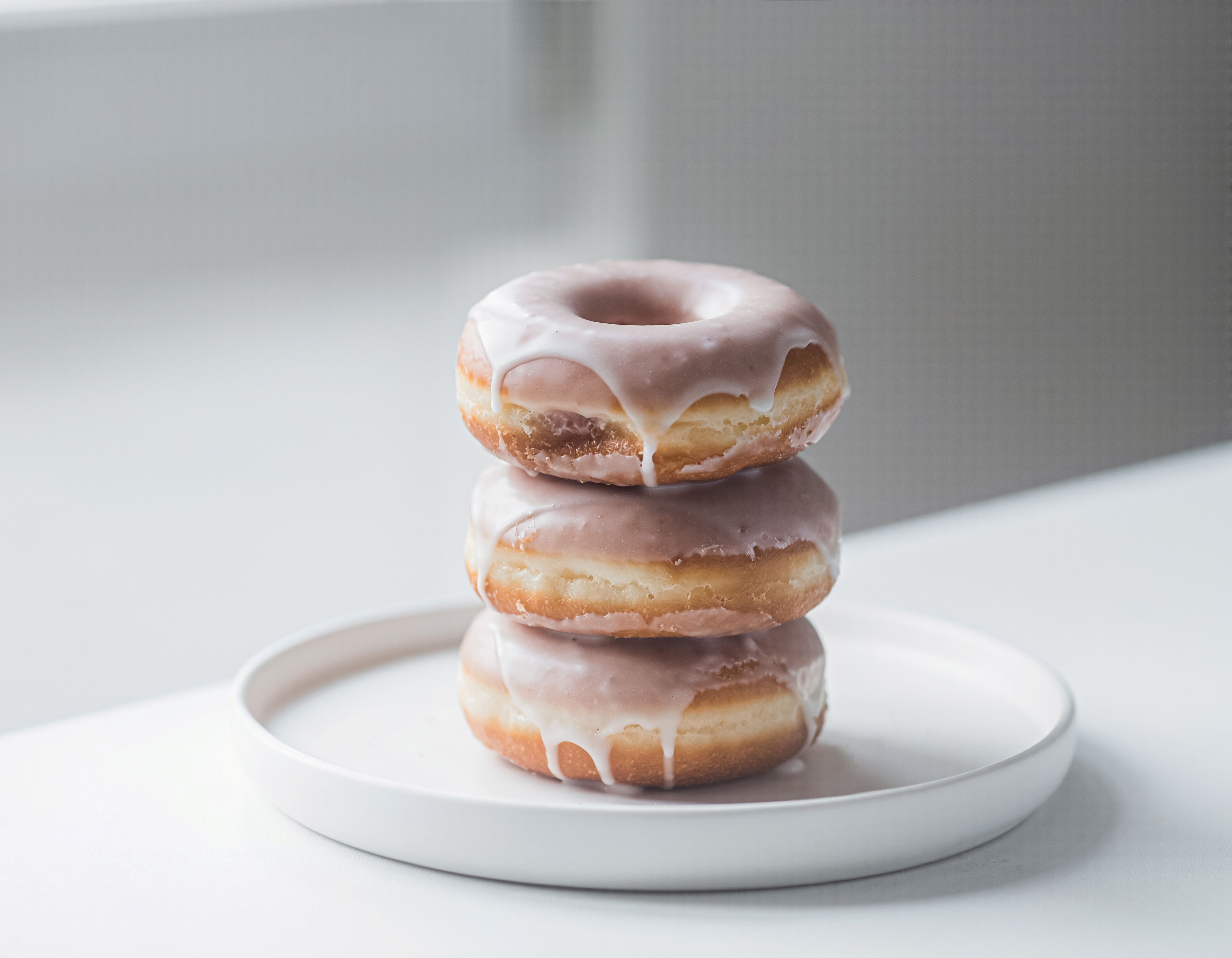 Assorted stuffed Bismark donuts with jelly and cream filling displayed on a rustic wooden table