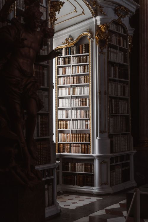 Free Elegant Admont Abbey Library corner with ornate rococo architecture and light-dappled bookshelves in Austria. Stock Photo