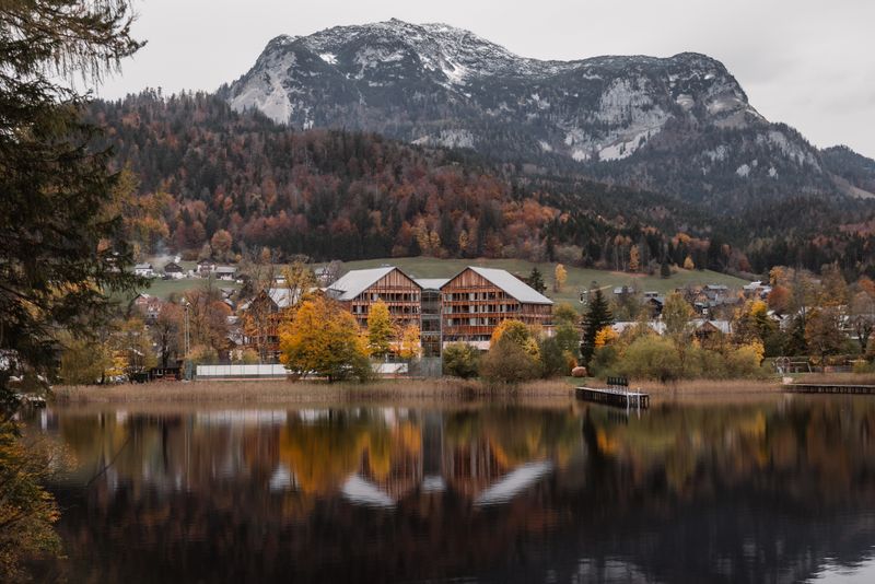 Picturesque autumn scene at Altaussee with a lakeside village and mountain backdrop. Perfect for travel inspiration.