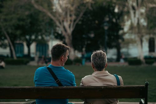 Free A couple enjoying a serene moment on a park bench in a Budapest park during the day. Stock Photo