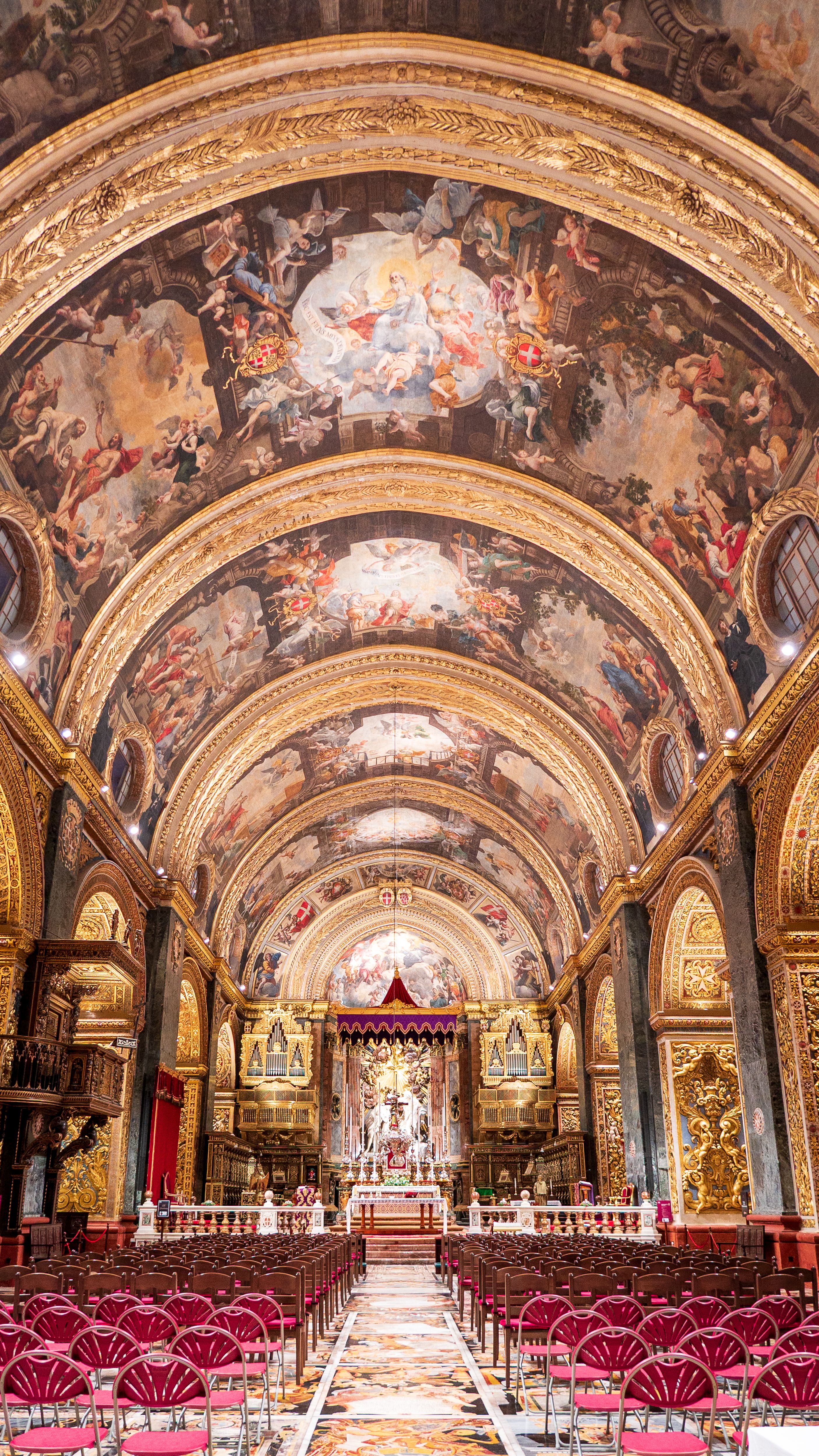 Interior view of St. John's Co-Cathedral in Valletta, Malta, showcasing ornate Baroque architecture and beautiful frescoes.