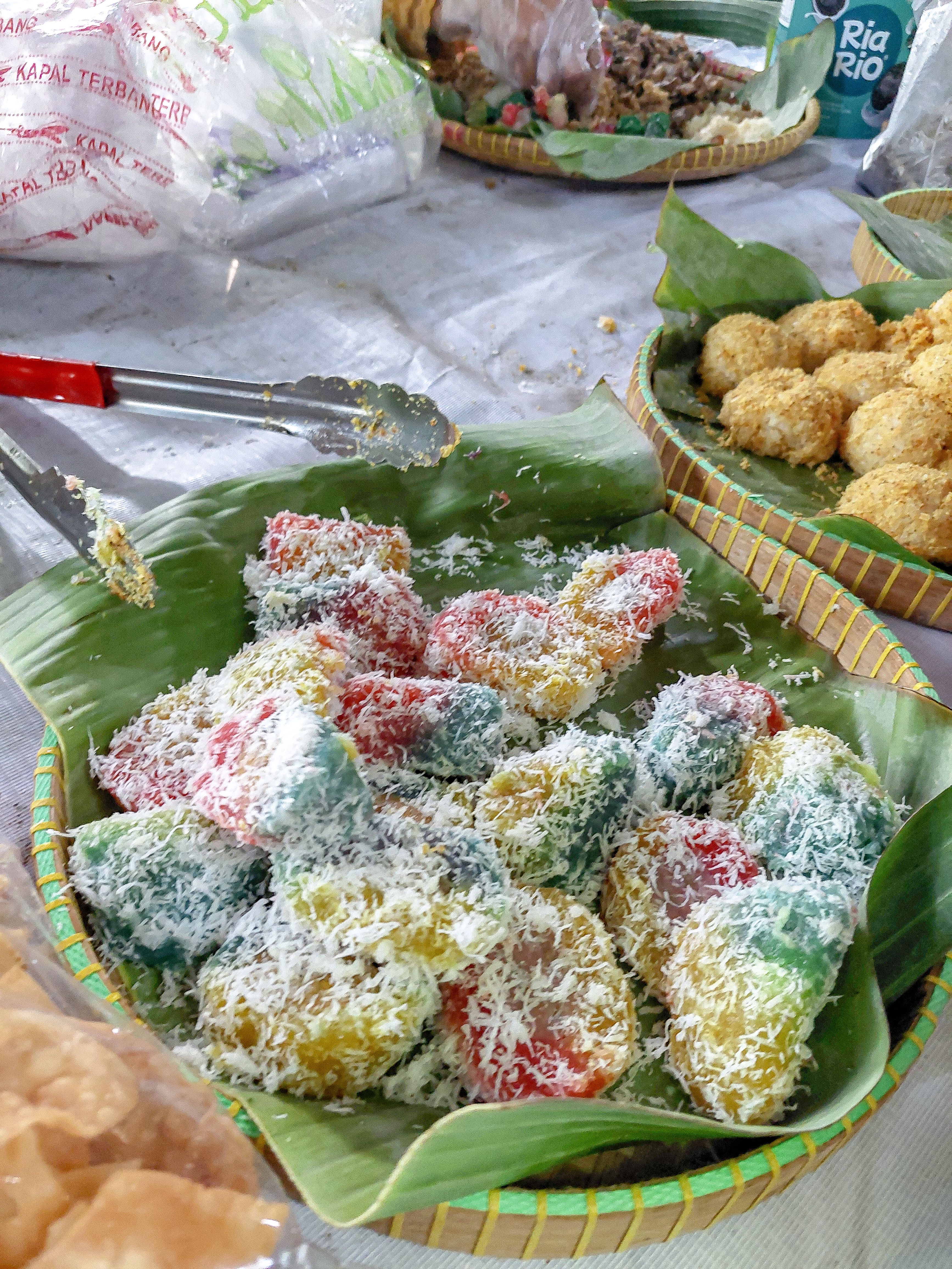 Klepon palm-sugar rice balls and dadar gulung pandan crepes with grated coconut served on a banana leaf as part of a Bali food guide tasting