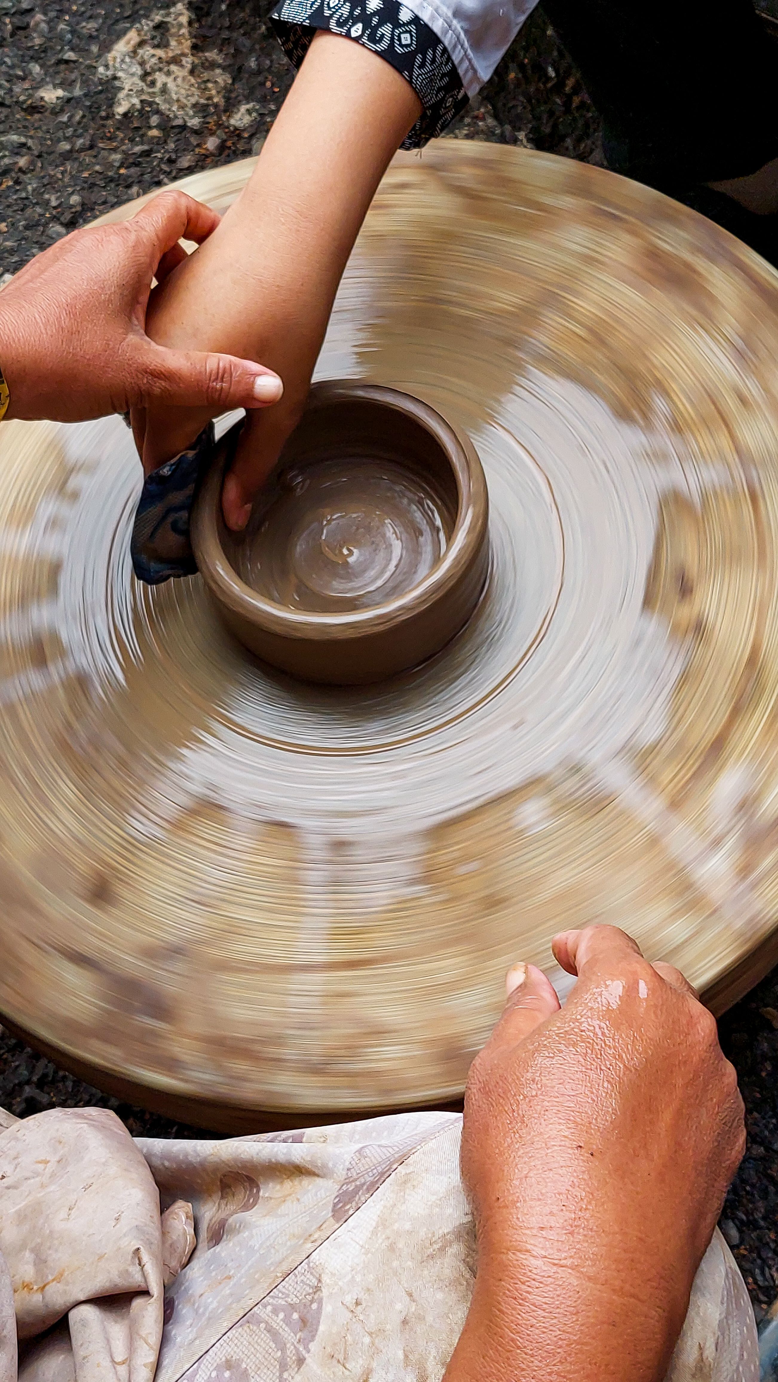 Hands centring clay on a pottery wheel — photo by Henny Wiyanti on Pexels