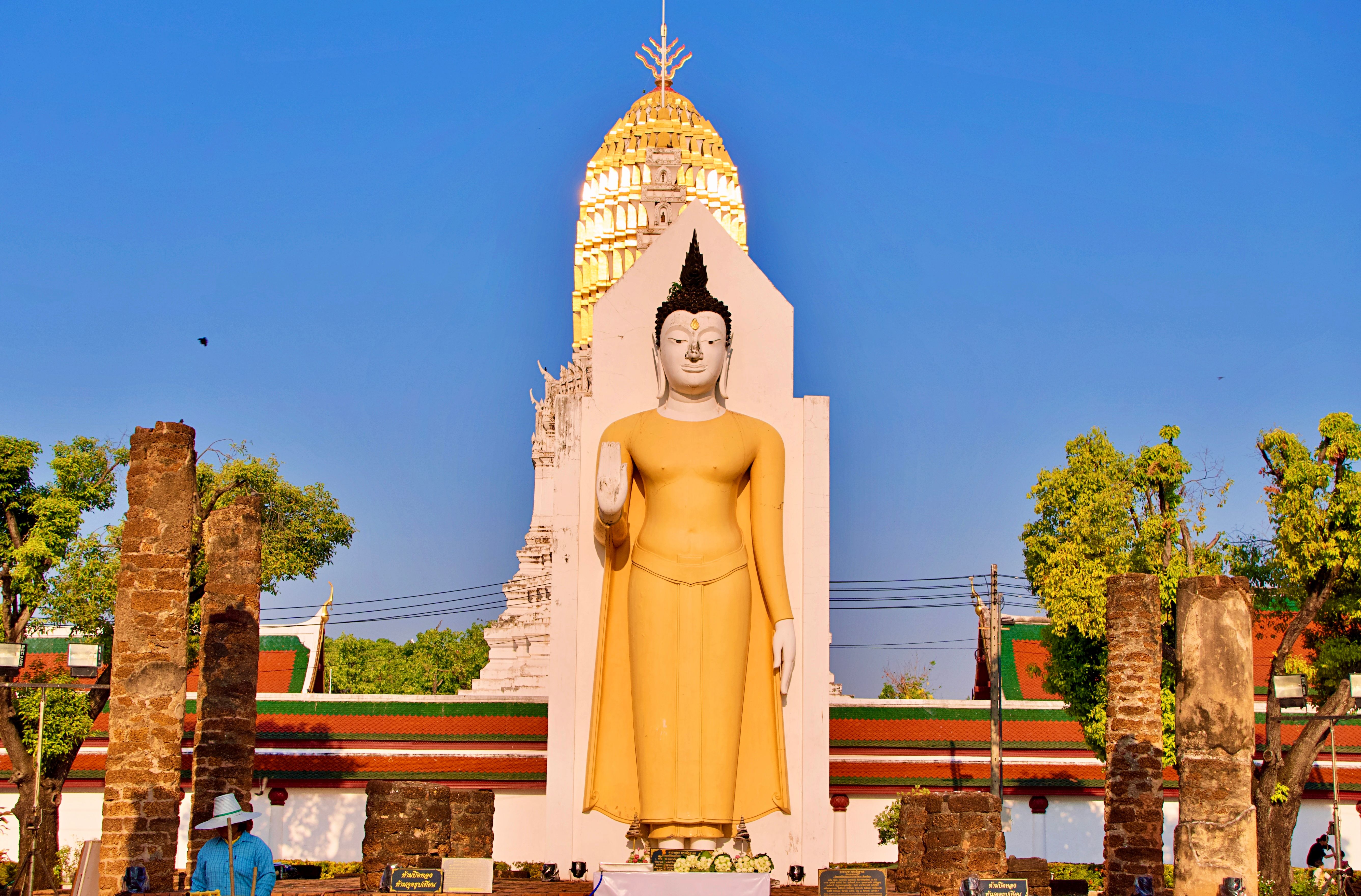 Impressive Buddha statue at Wat Phra Si Rattana Mahathat during a sunny day in Phitsanulok, Thailand.