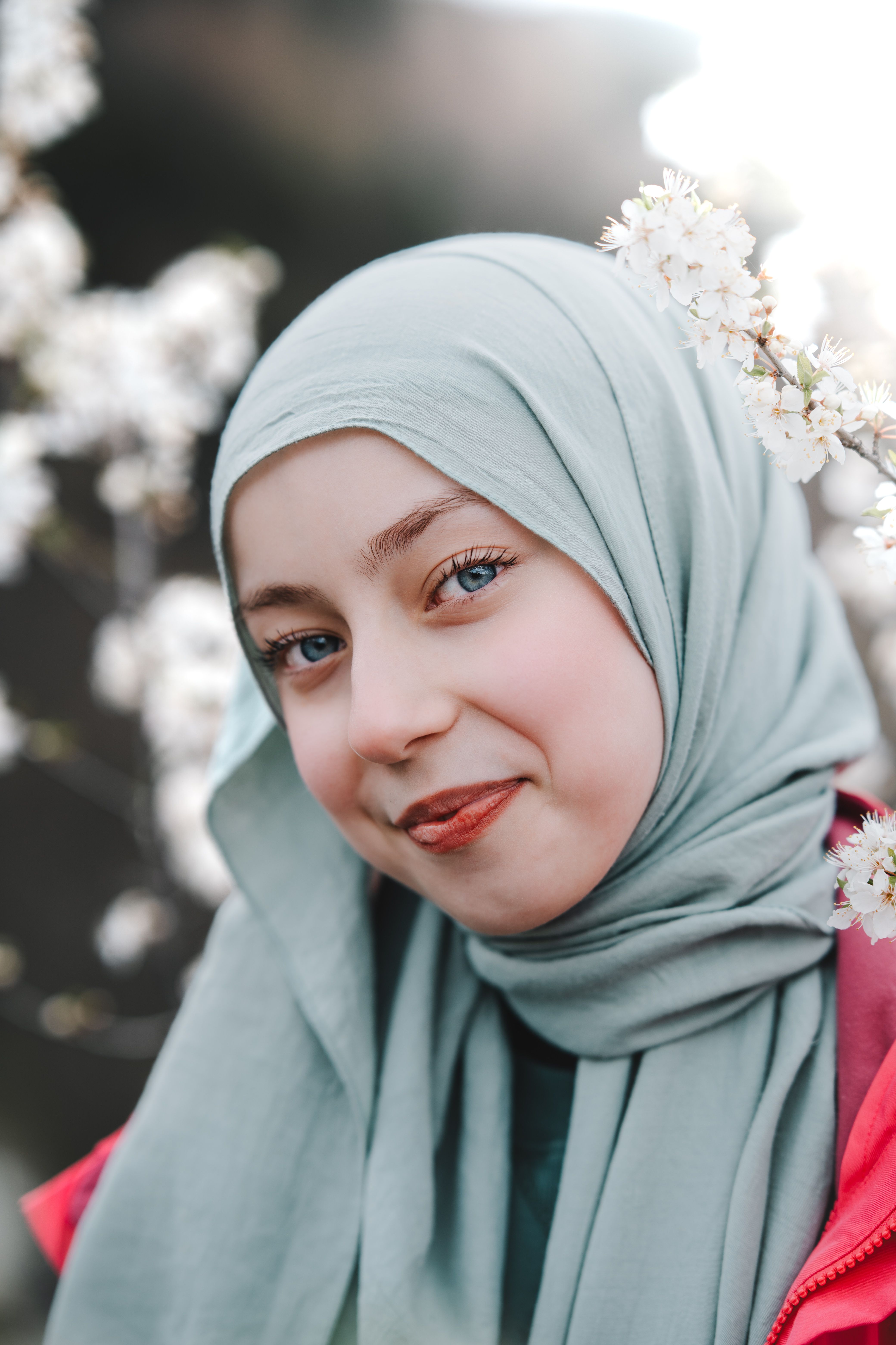 Portrait of a Smiling Woman in Spring Blossoms · Free Stock Photo